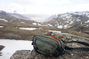 Dark Green X-Pac Tech & Trek Sling on snow mountain 